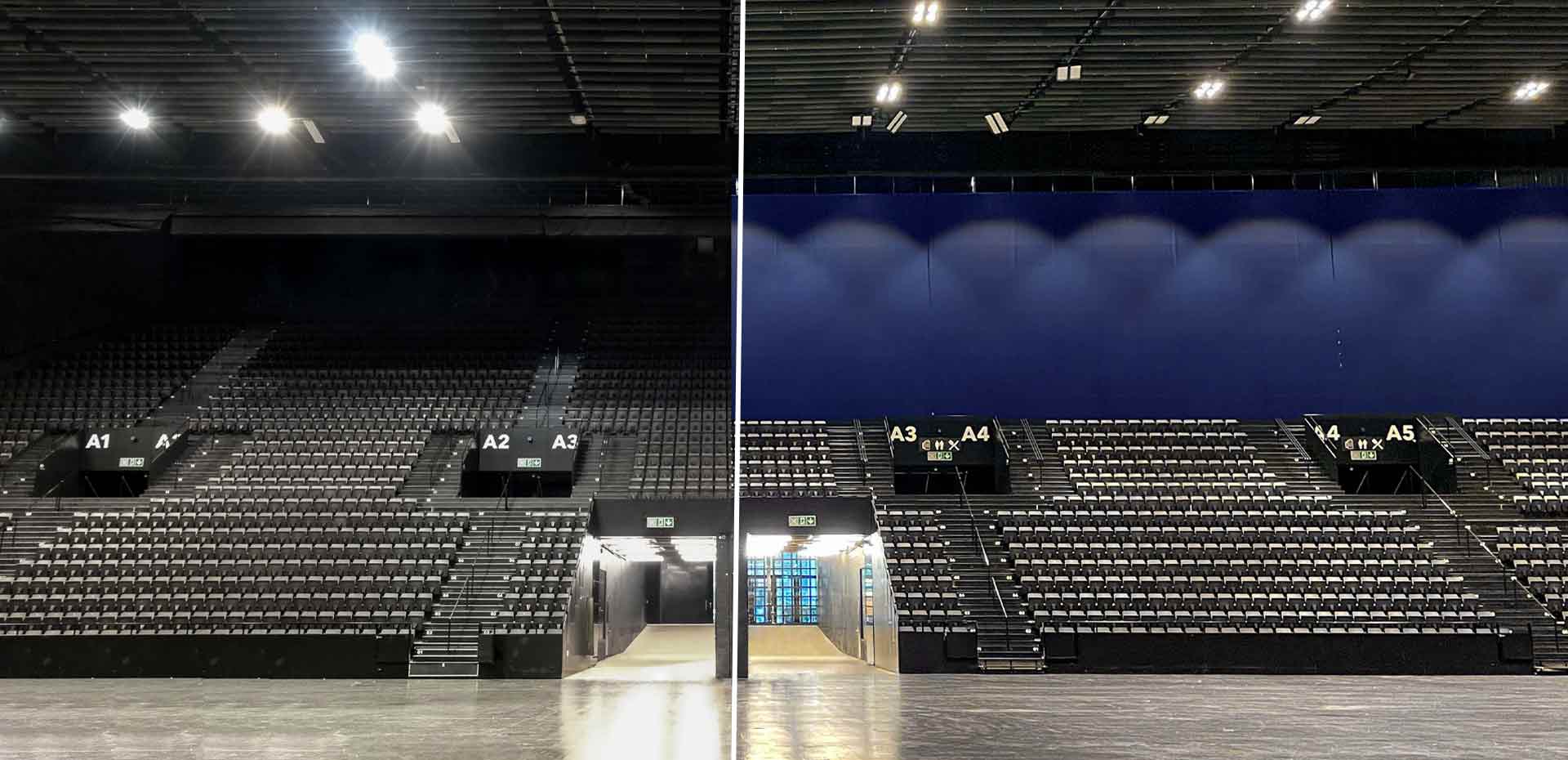 Ein leerer, dunkler Arena-Innenraum mit nummerierten Sitzreihen und Beleuchtung